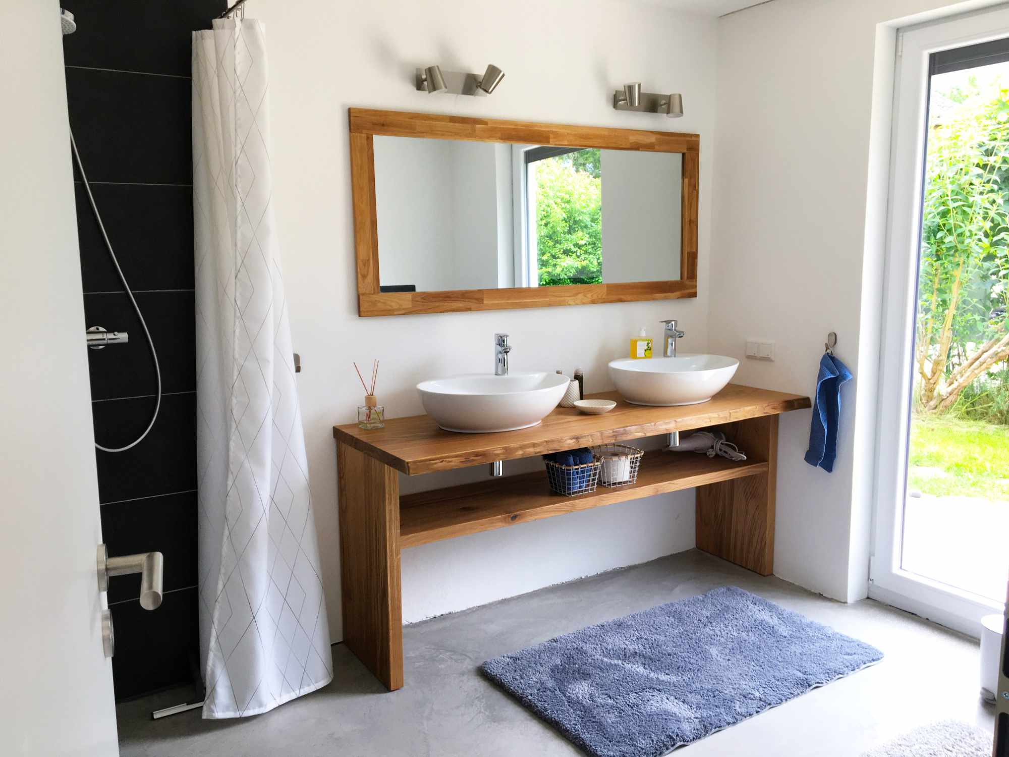 Badezimmer mit Waschbecken und Regendusche